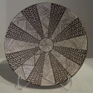 Fine line and geometric design on a black and white plate