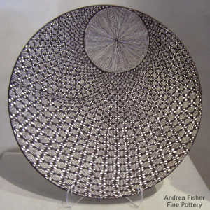 Fine line and geometric design on a black and white plate
