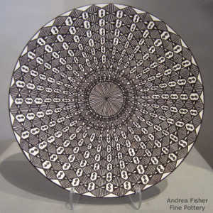 Fine line and geometric design on a black and white plate