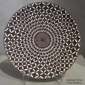 A fine line and geometric design on a black and white plate