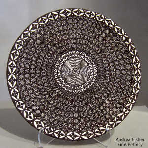 Fine line and geometric design on a black and white plate