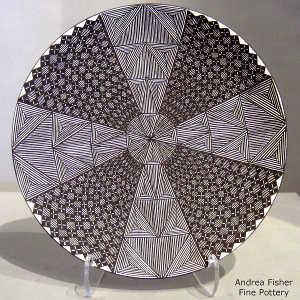 Fine line and geometric design on a black and white plate
