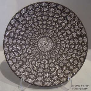 Fine line and geometric design on a black and white plate