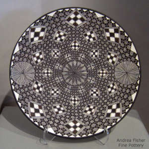 Fine line and geometric design on a black and white plate