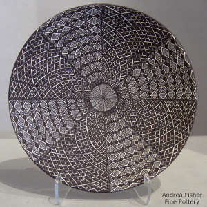 Fine line and geometric design on a black and white plate