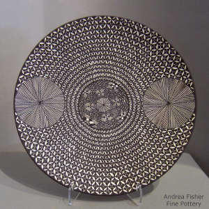 Fine line and geometric design on a black and white plate