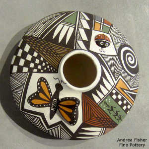 Lady bug, butterfly, shard and geometric design on a polychrome jar