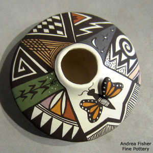 Lady bug, butterfly, fine line and geometric design on a polychrome jar