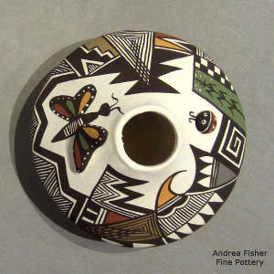 Lady bug, butterfly and geometric design on a polychrome jar