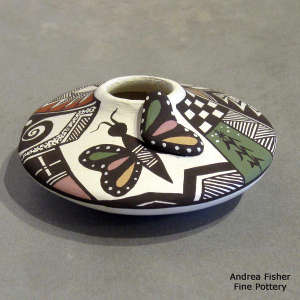 Lady bug, butterfly, corn plant and geometric design on a polychrome jar