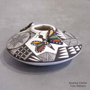 Butterfly, snowflake fine line and geometric design on a polychrome jar