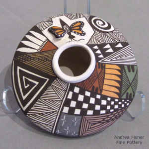 Butterfly, fine line and geometric design on a miniature polychrome jar