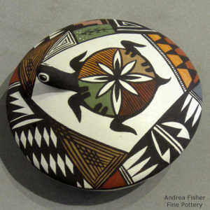 Shard, turtle and geometric design on a polychrome seed pot