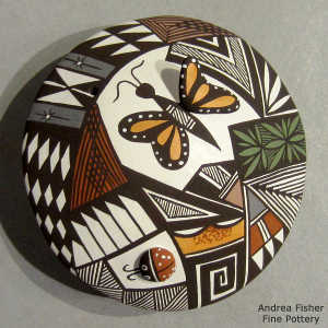 Lady bug, butterfly, shard and geometric design on a polychrome seed pot