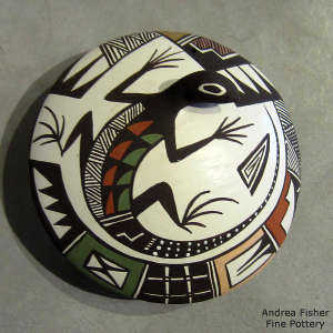 Lizard and geometric design on a polychrome seed pot