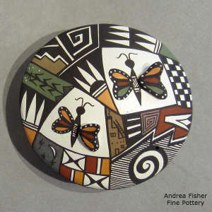 Butterflies and geometric design on a polychrome seed pot