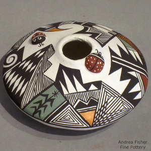 Geometric design and raised ladybugs on a polychrome seedpot