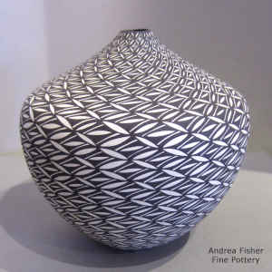 Pumpkin seed design on a black and white tear drop jar