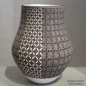 Fine line and geometric design on a black and white jar
