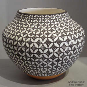 Black and white geometric design on a polychrome jar