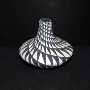 Spiral geometric design on a black and white jar