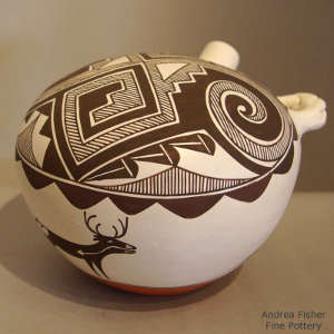 Deer, heart line, fine line and geometric design on a polychrome canteen