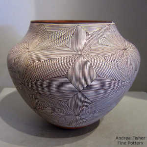 Black and white fine line snowflake design on a polychrome jar