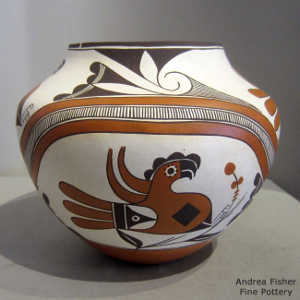 Parrot, flower, rainbow, cloud and geometric design on a polychrome jar