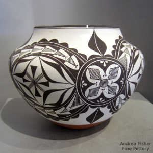 Black and white medallion and geometric design on a polychrome jar