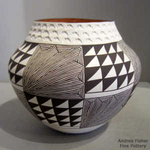 Fine line, step and geometric design on a polychrome jar with a band of corrugation around the neck