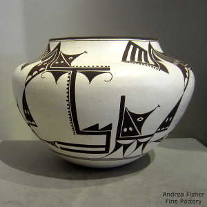 Cloud, bird element and geometric design on a black and white jar