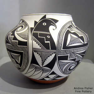 Black and white rain, medallion, stylized parrot and geometric design on a polychrome jar