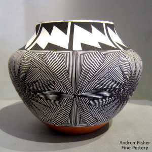 Black and white snowflake and fine line design on a polychrome jar