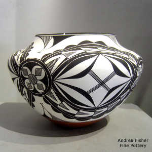 Black and white medallion and geometric design on a polychrome jar
