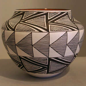 Fine line and geometric design on a black and white jar