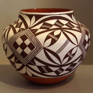 Black and white medallion and geometric design on a polychrome jar