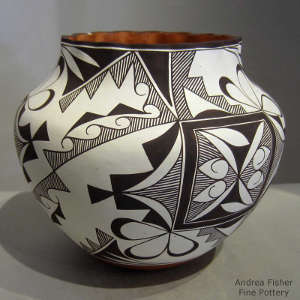 Black and white medallion and geometric design on a polychrome jar