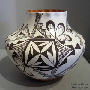 Black and white medallion and geometric design on a polychrome jar with a pie crust rim