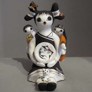 Two children, ladybug, cat and butterfly on a polychrome storyteller