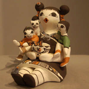 Two children, cat, birds, ladybugs and butterflies on a polychrome storyteller