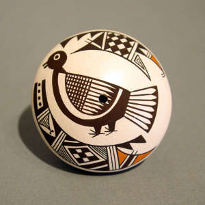 Stylized Mimbres turkey and geometric design on a polychrome seed pot