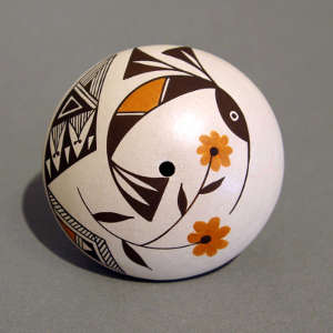 Floral plus Mimbres hummingbird and geometric design on a polychrome seed pot