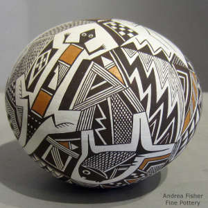 Mimbres animal, fine line and geometric design on a polychrome seed pot