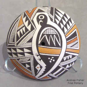 A Mimbres bird and geometric design on a polychrome seed pot