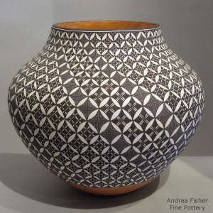 Swirled black and white geometric design on a polychrome jar