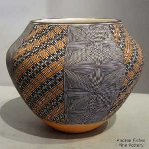 Fine line and geometric design on a polychrome jar