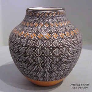 Fine line and geometric design on a polychrome jar