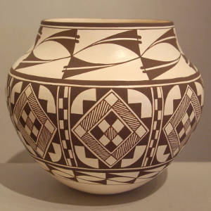 Eight panel geometric design on a black and white jar