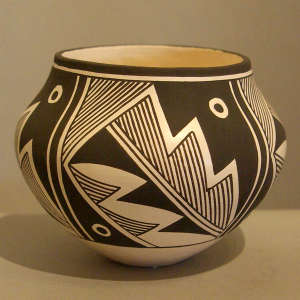 Fine line and geometric design on a black and white jar