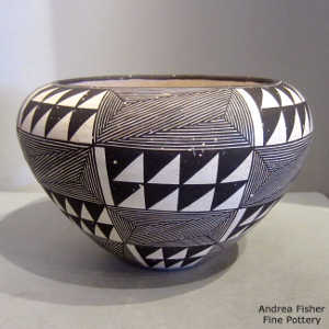 Fine line and geometric design on a black and white jar